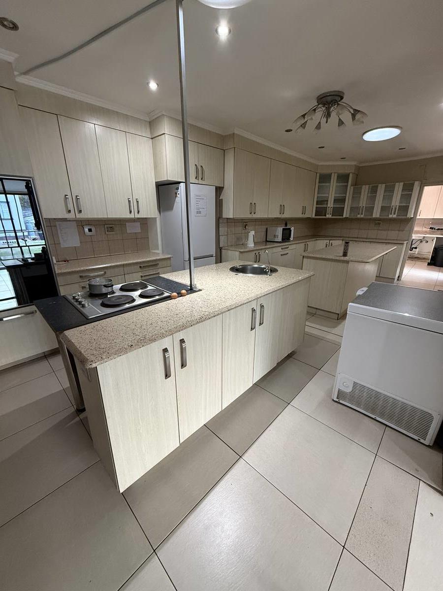 Kitchen — island with stove and sink